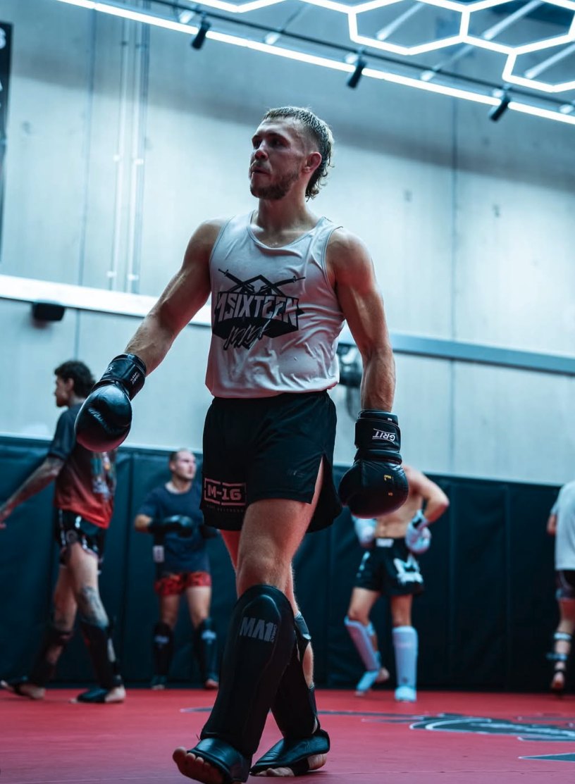 Krane Burke on the mats at M16, gloves and shin guards on, between rounds.